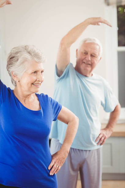 istock Senior couple performing stretching exercise 675206090