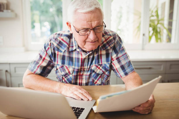 istock Worried senior man looking at a document 675206934
