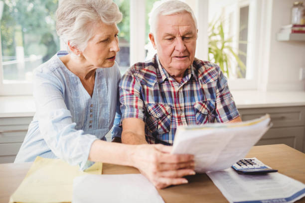 istock Worried senior couple checking their bills 675209262