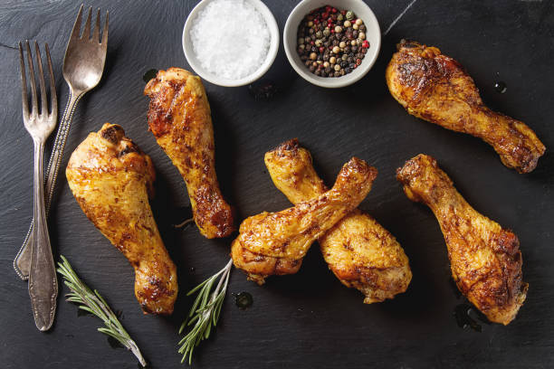 istock Fried chicken legs. Cooking for Christmas. Dark background. 675209396