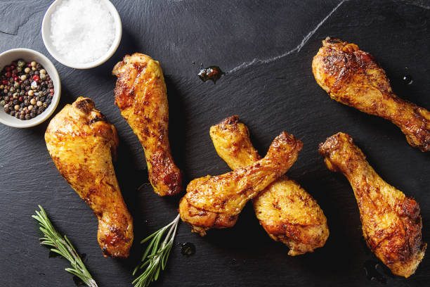 istock Fried chicken legs. Cooking for Christmas. Dark background. 675209408