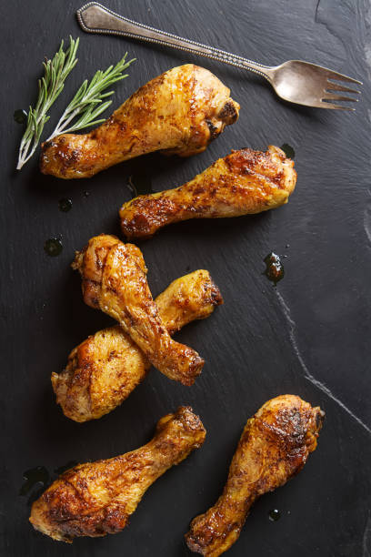 istock Fried chicken legs. Cooking for Christmas. Dark background. 675209448