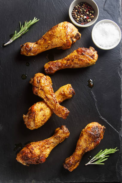 istock Fried chicken legs. Cooking for Christmas. Dark background. 675209452