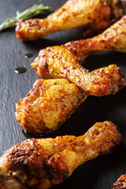 istock Fried chicken legs. Cooking for Christmas. Dark background. 675209474