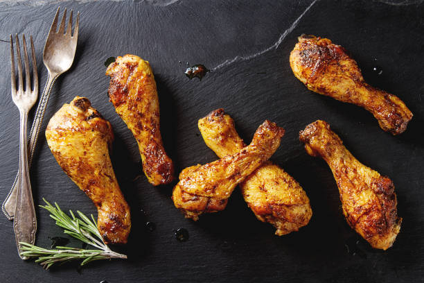 istock Fried chicken legs. Cooking for Christmas. Dark background. 675209544