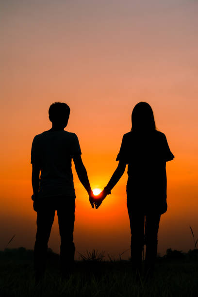 istock Silhouette couple holding hand 675213820