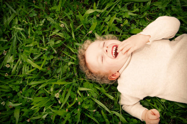 istock Laughing boy laying on the meadow 675216778