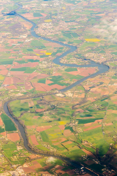 istock Aerial view on long waved river with many bridges nd fields with meadows around 675217350