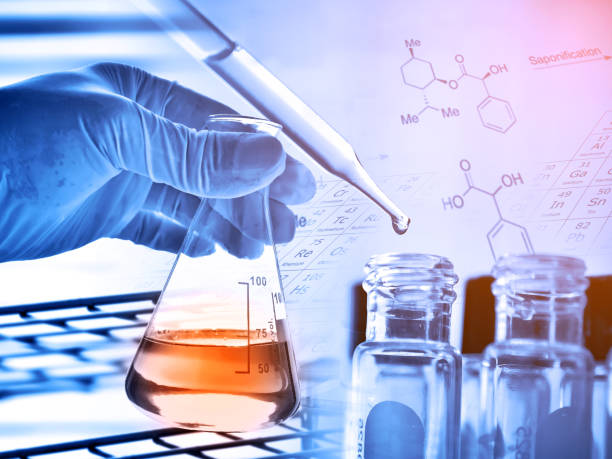 istock Flask in scientist hand with laboratory glassware background 675219704