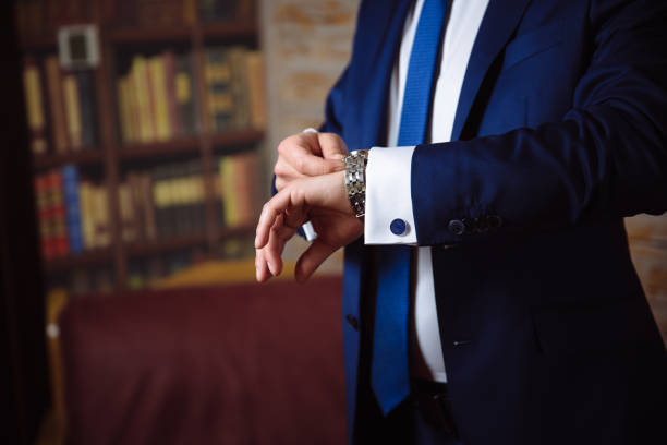 Groom hands with cufflinks and watches. Elegant gentleman clother, white shirt Business man hands with cufflinks. Elegant gentleman clother cufflink stock pictures, royalty-free photos & images