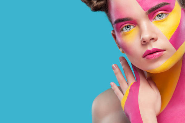 Portrait of the bright beautiful girl with art colorful painting make-up and bodyart. Copy space. stock photo