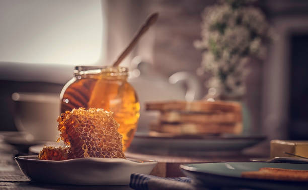 Preparing toast with butter and delicious honey for breakfast