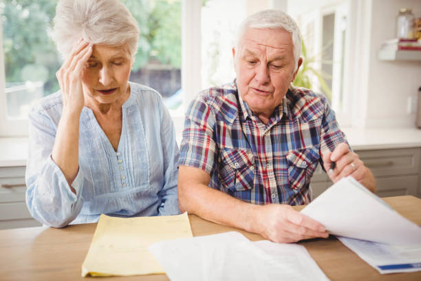 istock Worried senior couple checking their bills 675233110