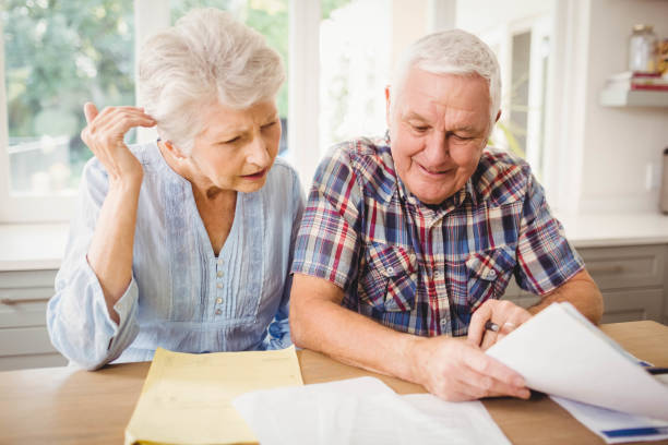 istock Senior couple checking their bills 675233142