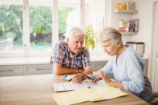 istock Worried senior couple checking their bills 675233266