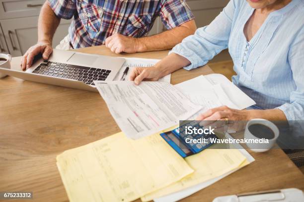 Senior Couple Checking Their Bills Stock Photo - Download Image Now - Financial Bill, Senior Adult, Table