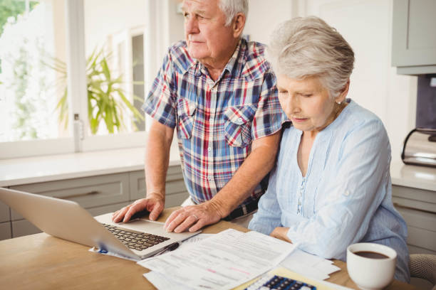 istock Senior couple checking their bills 675233344