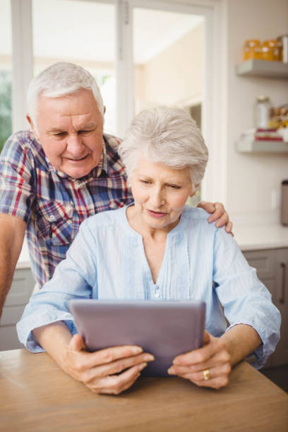 istock Senior couple looking at a digital tablet 675233606