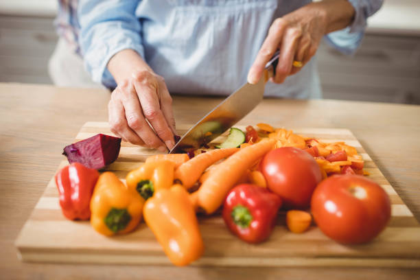 istock Senior woman chopping vegetables 675234060