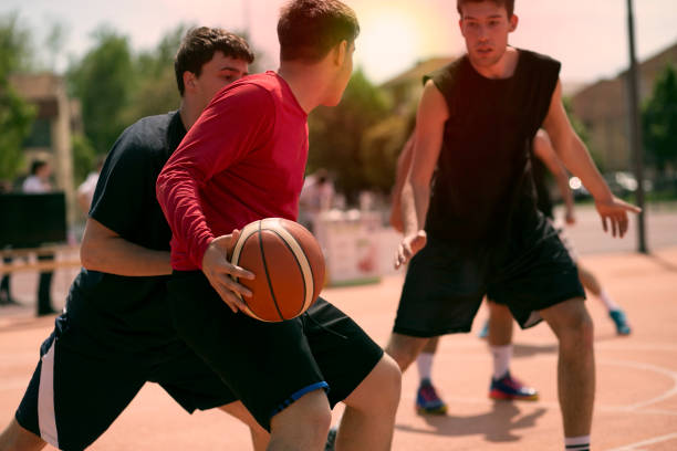 istock Group of friends playing basketball 675234122
