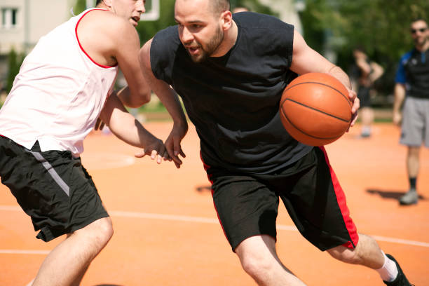 Group of friends playing basketball stock photo