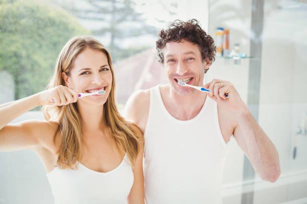 istock Happy couple brushing teeth 675239888