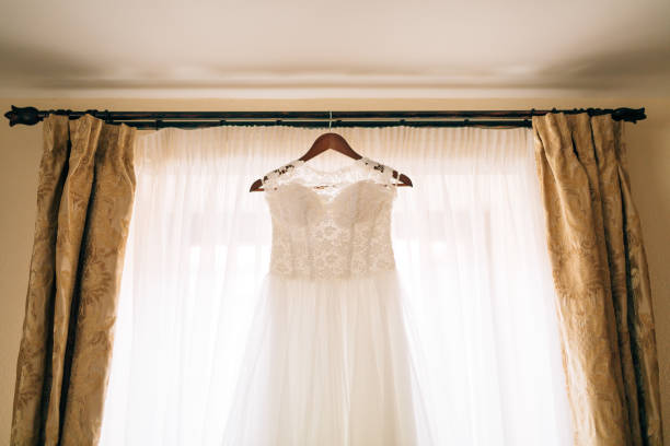 istock The bride's dress hangs on the cornice 675240078