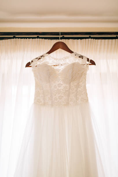 istock The bride's dress hangs on the cornice 675240112