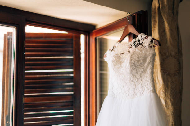 istock The bride's dress hangs on the cornice 675240276