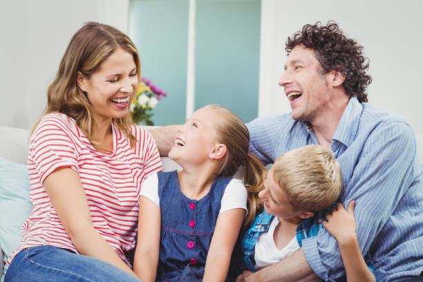 istock Cheerful family on sofa 675240418