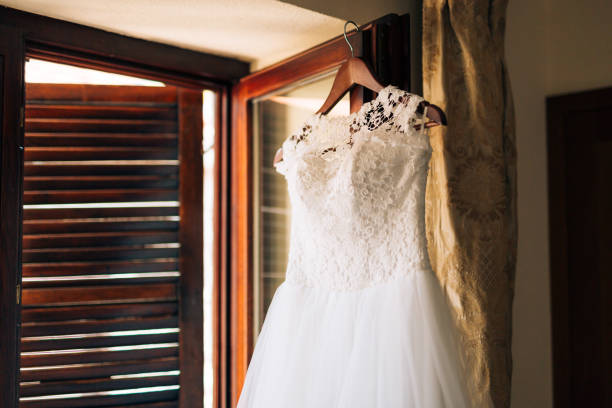 istock The bride's dress hangs on the cornice 675240468