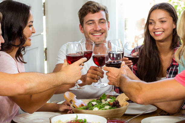 istock Friends toasting wine glasses 675244434