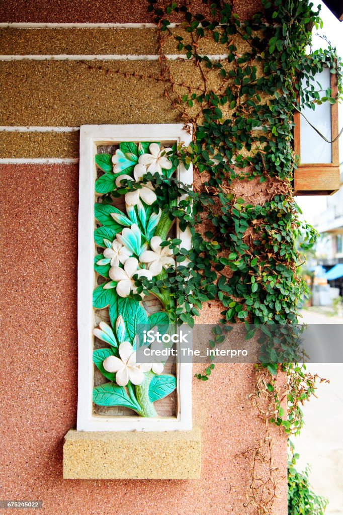 The stems of the ivy creep along the stone wall. The stems of the ivy creep along the stone wall at home. Abstract Stock Photo