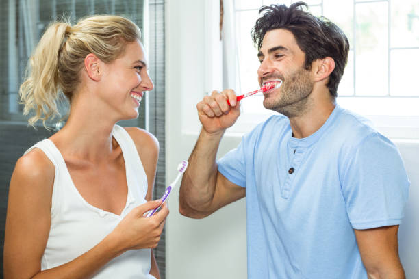 istock Couple brushing their teeth in bathroom 675247486