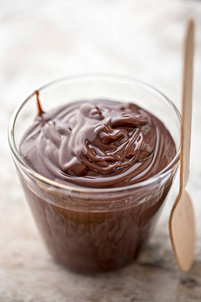 istock Chocolate pudding in glass with wooden spoon 675251632
