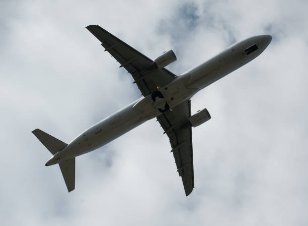 istock Silhouette of airplane passing by overhead 675254974