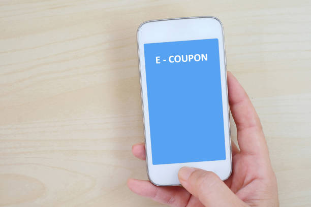 istock Hand holding smart phone with e-coupon on screen, business and technology concept 675258538