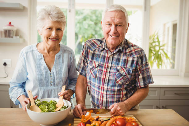 istock Senior couple preparing salad 675259508