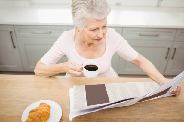 istock Senior woman reading a newspaper 675262002