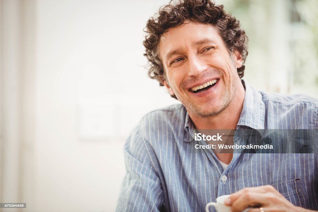 Portrait of mature man smiling Portrait of mature man smiling at home Men Stock Photo