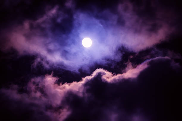 The moon on the dark sky The moon on the dark sky among the clouds, natural abstract background horror world stock pictures, royalty-free photos & images