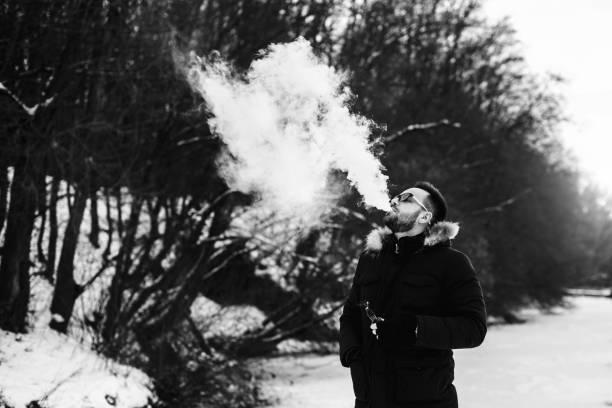istock Man smoke electronic cigarette outdoor 675267752