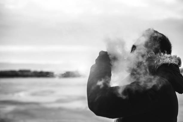istock Man smoke electronic cigarette outdoor 675267788