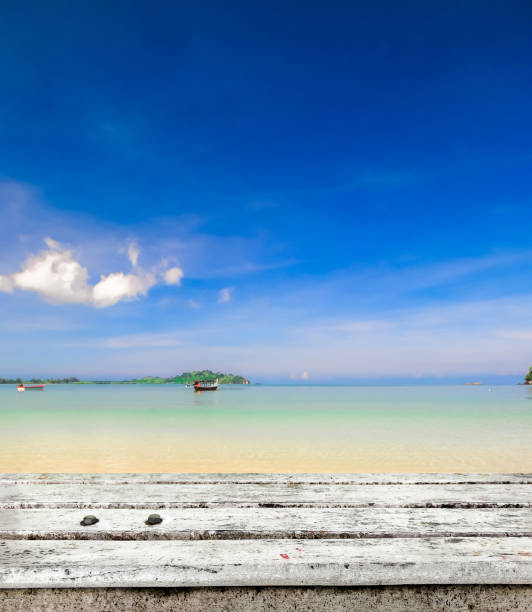 istock wooden tabletop on peaceful beach 675268400
