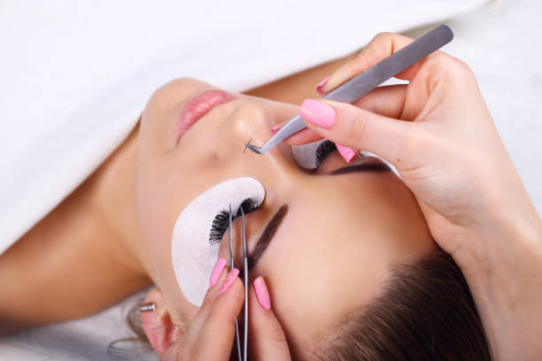 istock Eyelash Extension Procedure. Woman Eye with Long Eyelashes. Lashes, close up, macro, selective focus 675268428