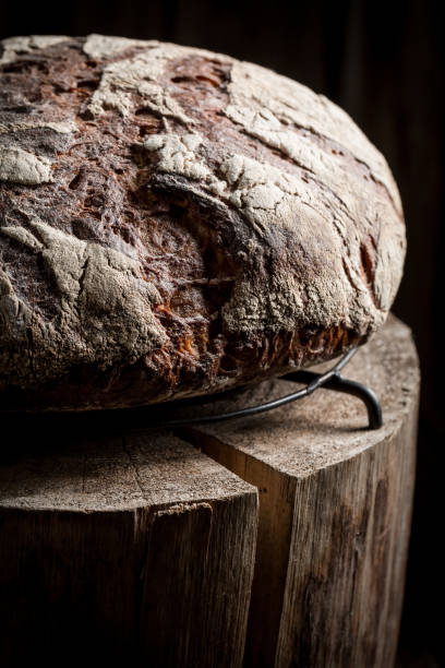 istock Healthy and fresh bread with whole grains on dark table 675268742