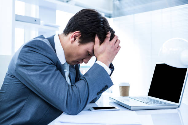 istock Sad businessman holding his head 675269184