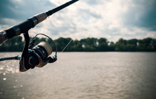 istock fishing rod and river 675269442