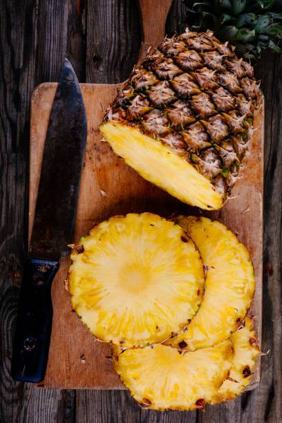 istock Fresh raw organic pineapple on a wooden background 675271746