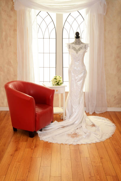 Wedding dress on mannequin with window Wedding dress on mannequin with window with red chair red evening gown mannequin indoors stock pictures, royalty-free photos & images